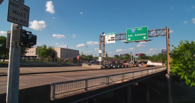 A captivating timelapse of the I-10 West San Antonio directional freeway sign in downtown Houston, Texas.