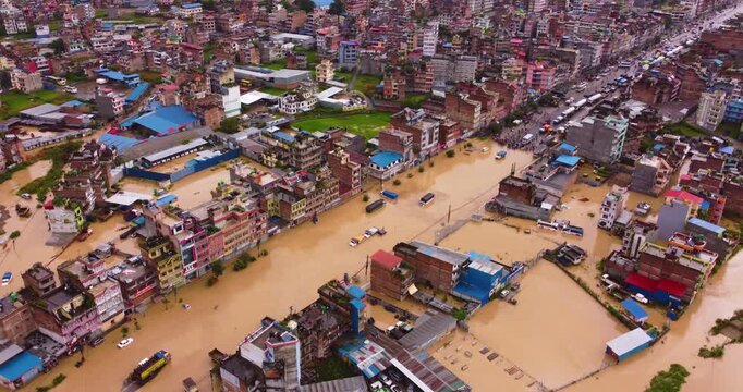 Aerial view of severe monsoon flood in Banepa submerging homes with river overflow and highway blockage, highlighting urban vulnerability and drainage issues near Kathmandu, Nepal.