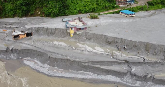 Drone shot of Melamchi hamlet Nepal showing houses buried and filled with sand after severe flooding, highlighting destructive impact of monsoon.