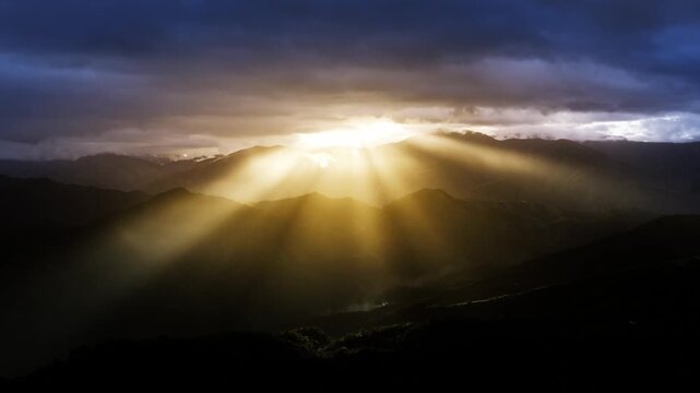 Slow zoom capturing powerful sun rays breaking through clouds over Hingyon