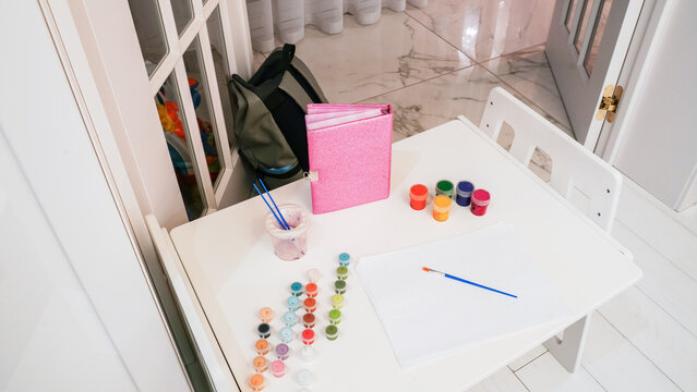 Creative activity at a table with paint supplies in a bright room on a weekend afternoon