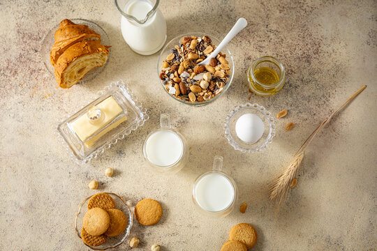 Healthy breakfast table setting with muesli , milk , butter, egg.