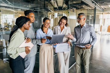 Development team reviews demonstration while smiling and planning features