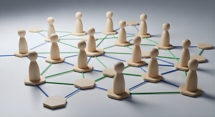 Obraz premium Wooden pawn figures arranged in a network formation on a light gray surface connected by blue and green lines symbolizing teamwork