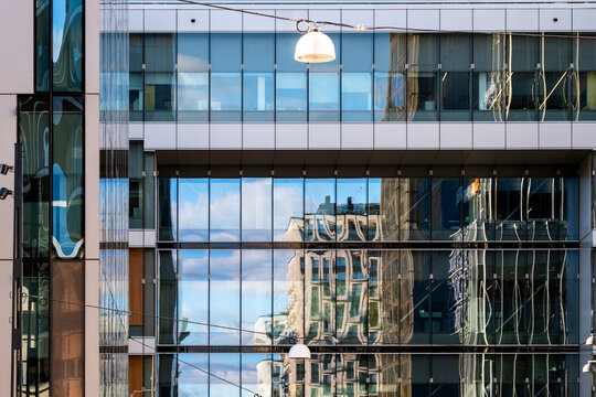 Symmetry and reflection in modern glass windows on geometric exterior of a facade architecture building offering sleek corporate backdrop