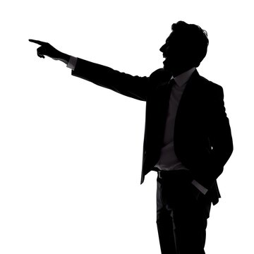Silhouette of a businessman pointing at a screen or whiteboard, side profile, wearing a tie and suit, energetic pose, isolated on white