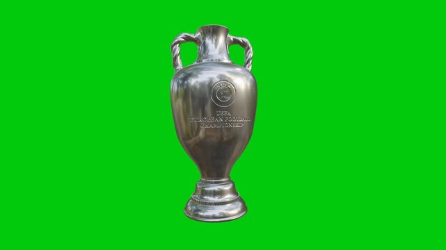 Silver trophy gleams against vibrant green screen