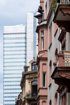 Historic facade meets modern architecture in corporate Frankfurt Bankenviertel Germany where skyline and contrast define an evolving urban street