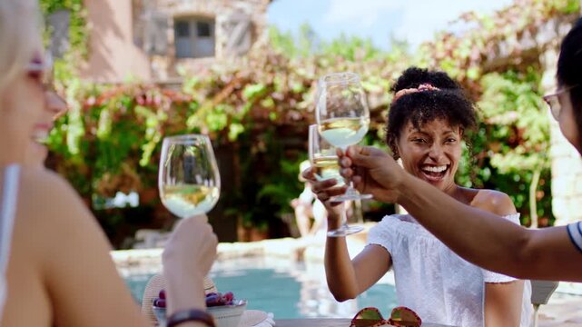 Woman, friends and cheers with wine at villa for summer holiday, friendship celebration or reunion. Poolside, happy people or drinks toast at lodge for social gathering, gratitude or vacation bonding