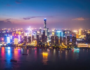 Fototapeta premium A stunning aerial view captures the vibrant cityscape of Shanghai at twilight, showcasing its impressive skyline and reflecting lights on the Huangpu River.