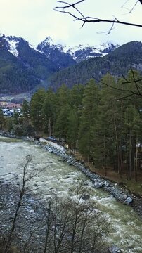 A wide mountain river on a cloudy day. A bird's eye view of a spring forest.