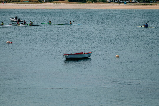 People paddling kayaks on calm seas