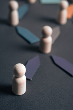 Abstract depiction of leadership and organization with wooden figures and geometric forms in harmonious arrangement.