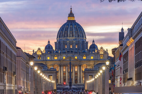 St. Peter's basilica in Vatican and road of Conciliation in Rome, Italy at sunset (translation "In honor of prince of Apostles; Paul V Borghese, Pope, in year 1612 and 7th year of his pontificate)