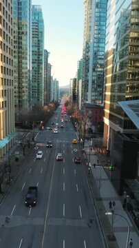 Flight between skyscrapers along the street in Downtown of Vancouver
