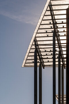 Steel canopy structure in minimal architecture shows strong geometry and lines in perspective against open sky highlighting modern framework design