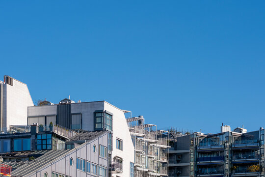 Modern city architecture shows urban buildings and rooftops in blue sky at daylight capturing density in skyline patterns for housing themes