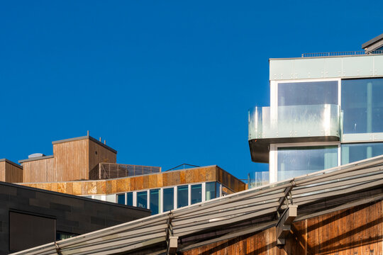 Modern rooftop architecture building with minimal geometry and lines in sunlight against clear sky leaving ample copyspace for design use