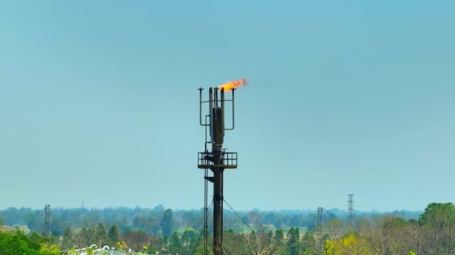 A drone shot of a refinery flare system burning excess gas, representing energy production, oil processing technology, and industrial activity linked to fossil fuels and environmental considerations.
