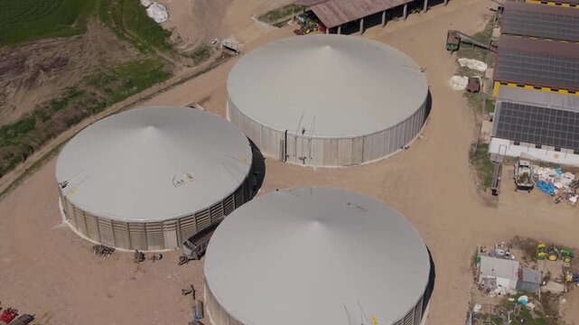 Drone view of agricultural biogas tanks and anaerobic digesters in Italy.