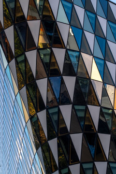 Modern architecture facade on a tower with glass diamonds where geometry pattern and reflections create rich texture for abstract background design