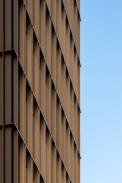 Minimalism in modern architecture facade where vertical lines and texture on wall define geometry under open sky for abstract background use