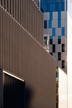 Modern architecture facade corner with windows where perspective lines and geometry meet texture and shadows for dramatic abstract background