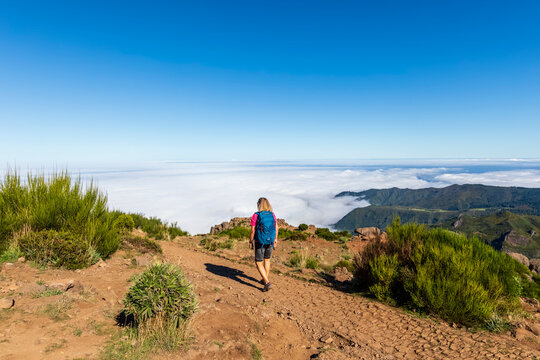 Tourist hiking along scenic trail at Pico do Areeiro Madeira Portugal