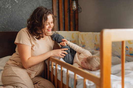 Mother and child enjoying playful bedtime routine in cozy home