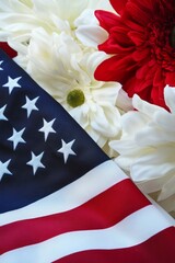 Obraz premium Memorial Day. American flag gently folded with red and white flowers arranged on top, featuring vibrant red gerbera daisies and white chrysanthemums against a soft background