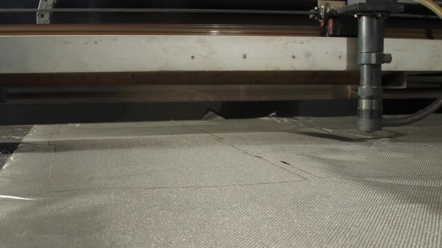 Laser blade severs fabric transforming into shielding layers. Faraday cloth uses for medical equipment requiring protection from electromagnetic interference