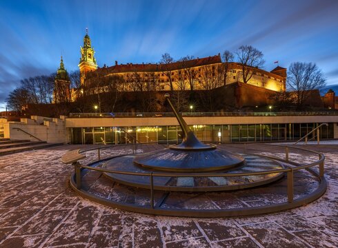 Modern sundial with Wawel Royal Castle at blue hour, Krakow, Poland