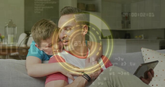 Holding tablet father wearing raglan tee and tracker, sitting on sofa, child hugging, AR overlay