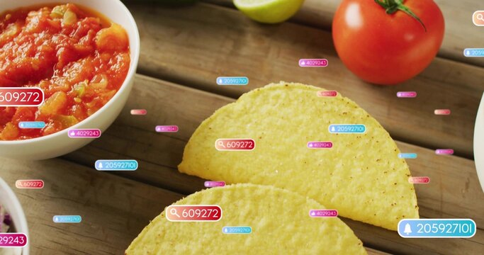 2 yellow corn taco shells sitting on wood table, showing salsa, tomato-lime, UI-tags magnifier bell