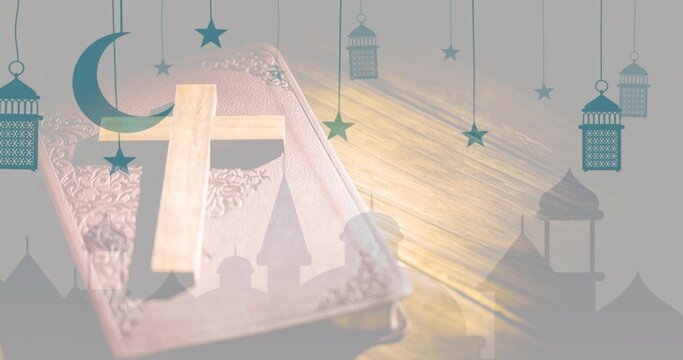 Resting closed ornate leather book on wood table, showing small cross and crescent moon silhouettes