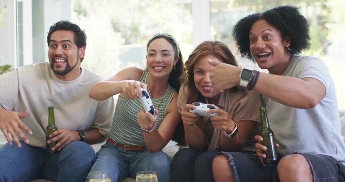 Diverse friends laughing, focusing on game starting, competing with controllers and beer on couch