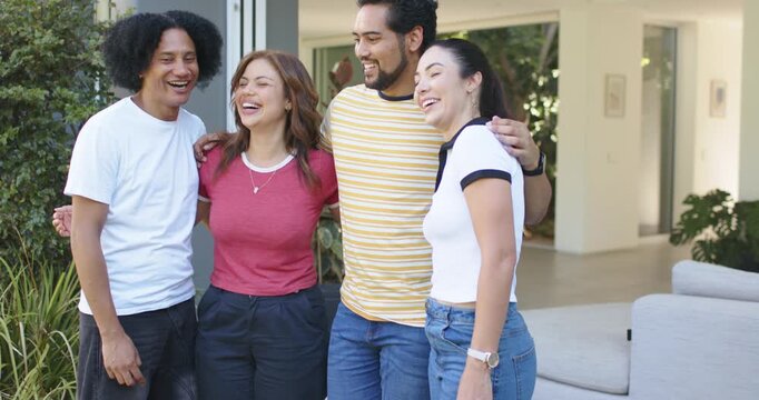 Vertical video: Group of four friends leaning at open door, right placing arm, arranging promo