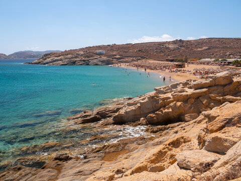 Panoramic view of Lia beach with tourists on the island of Mykonos in Greece.