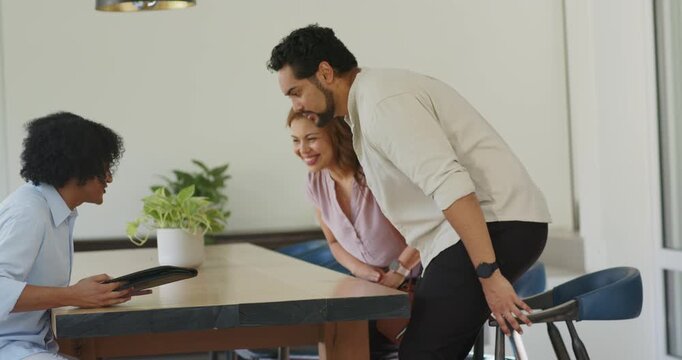 African American couple meeting agent placing folio on long table, reviewing and signing with pen