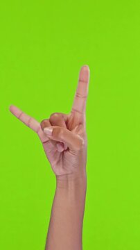 Hand form rock gesture for a bold, playful photo with vibrant green background, showcasing hands and wrist motion and dynamic composition suitable for advertising, social media, and creative projects