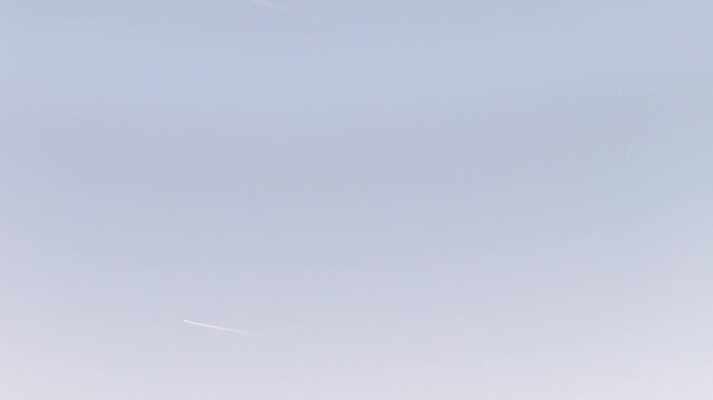 Minimal sky wallpaper with planes contrails and soft pastel sunset colors