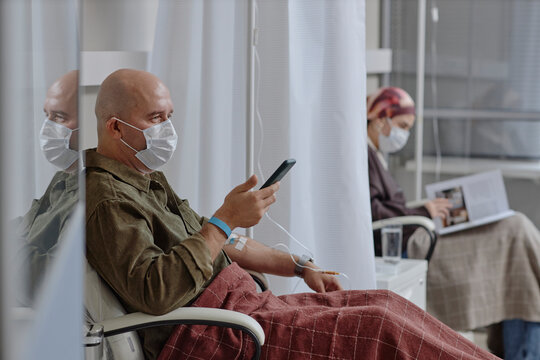 Patients receiving IV therapy in clinic setting with masks