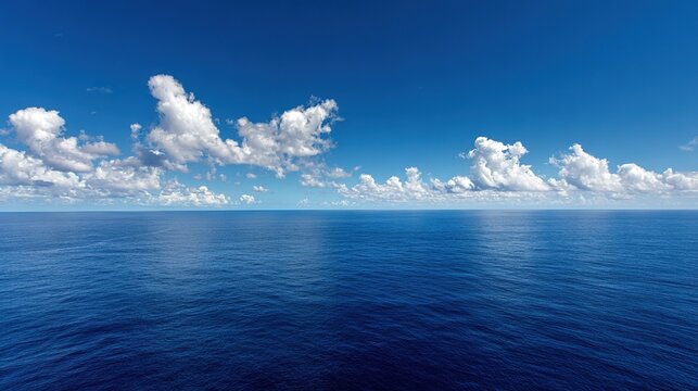 Endless expanse of the deep blue ocean beneath a bright blue sky