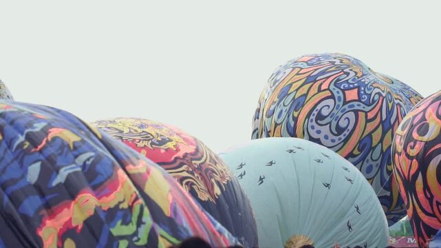 Vibrant hot air balloons with unique artwork, symbolizing freedom, tourism, and scenic exploration. Wonosobo balloon festival, Indonesia.