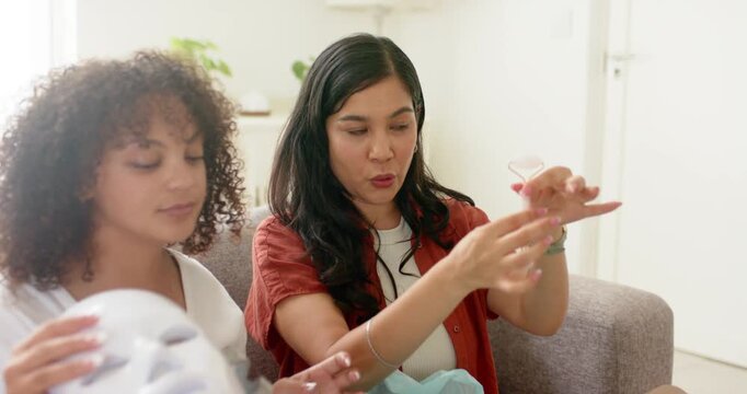 Demonstrating right wearing rust shirt rotating pink roller on home sofa, left holding white device