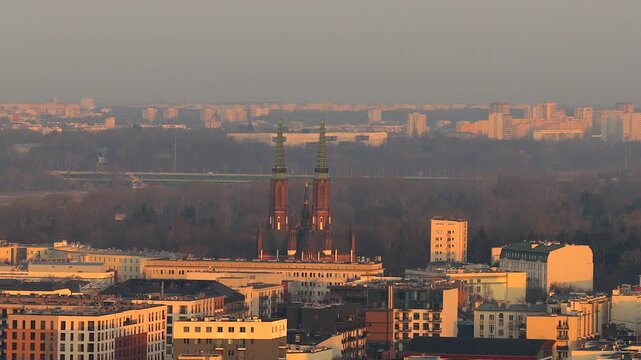 Golden sunset light illuminating the cityscape of warsaw, poland. Aerial perspective showing the historic saint florian's cathedral and surrounding praga district