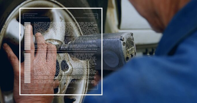 Inspecting technician in blue shirt pressing alloy rim in garage, with HUD overlay and control box