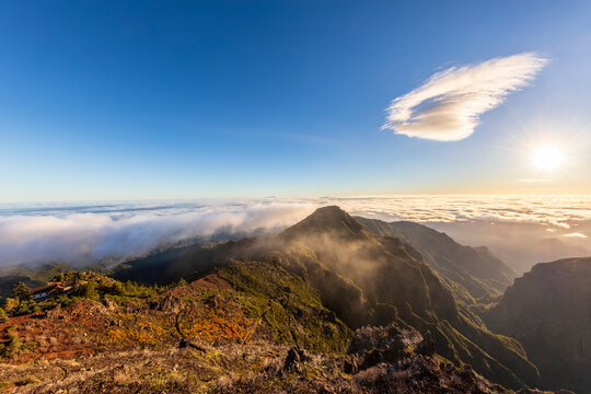 View from Pico Ruivo overlooking mountains and Casa de Abrigo at sunrise