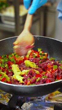 Vertical Shot of Turkish Coban Kavurma Sizzling and Mixing in Deep Pan