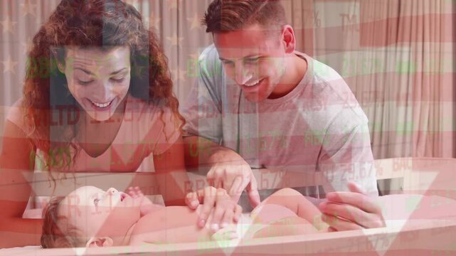 Animation of flag of usa waving over happy caucasian parents playing with baby